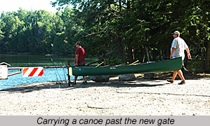 carrying a canoe past the new gate